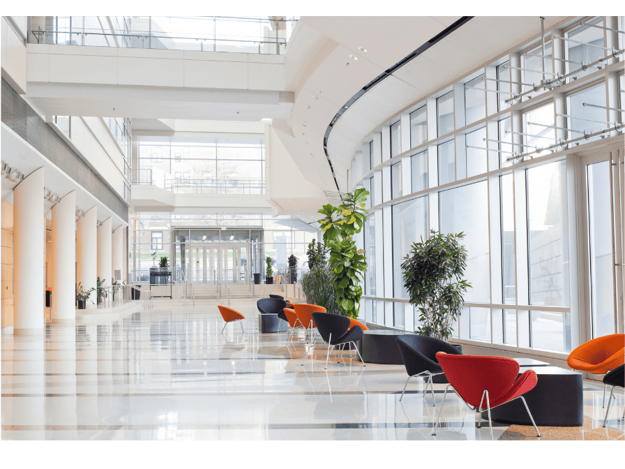 Corporate office lobby with floor-to-ceiling glass windows — ESG real estate consulting for tenants across Canada